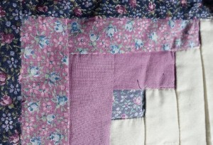 A square from my first quilt, tiny light blue, purple, and pink flowers mixed with a pink-purple. I loathe calicoes now.