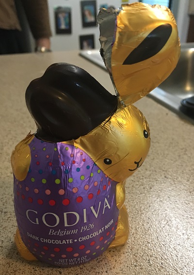a chocolate bunny with the foil delicately cut away from the ears